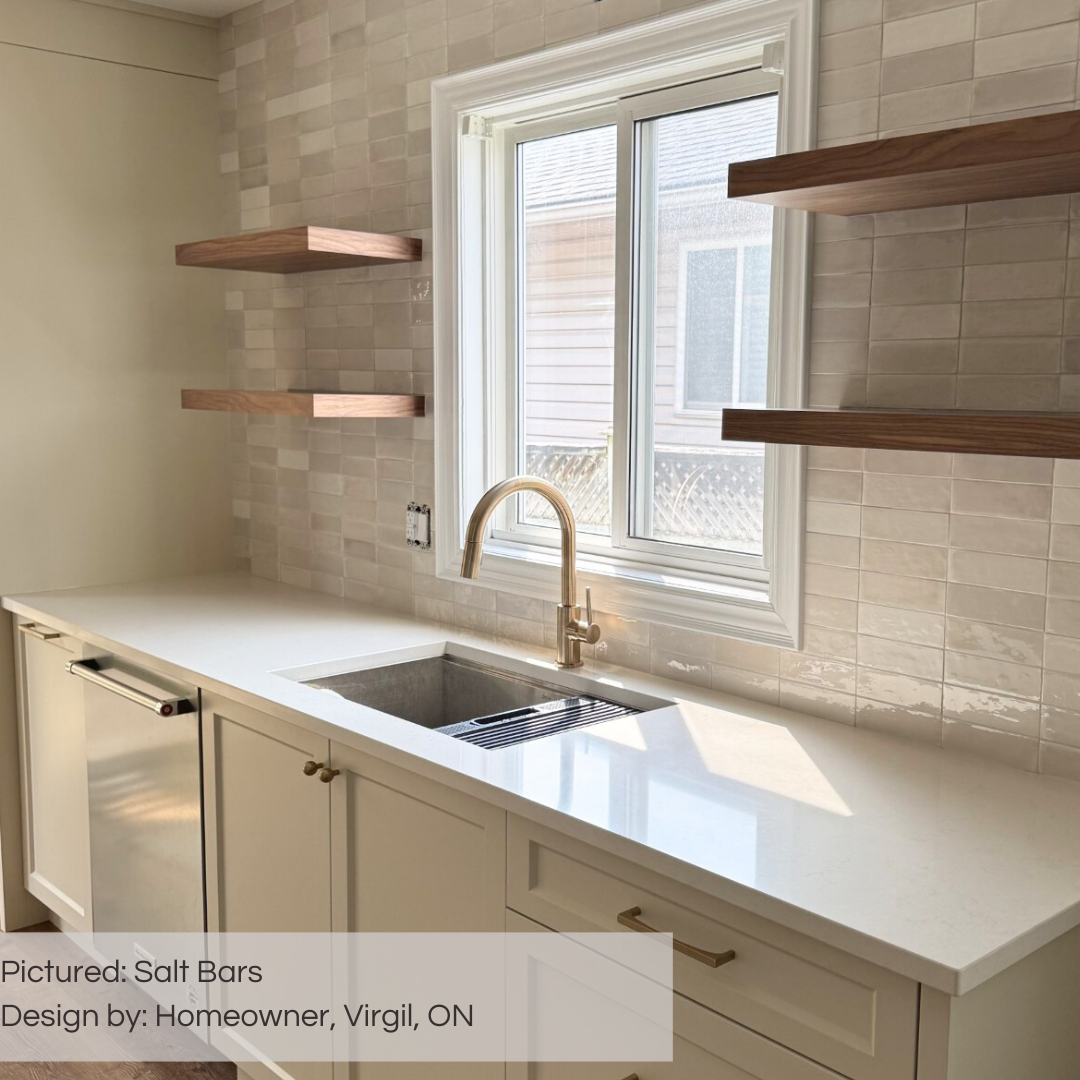 A warm minimalist modern kitchen with open shelving and cream cabinets, the entire backsplash wall is tiled using 2x6.5 salt bars subway tiles with colour variation laid out in a horizontal stack