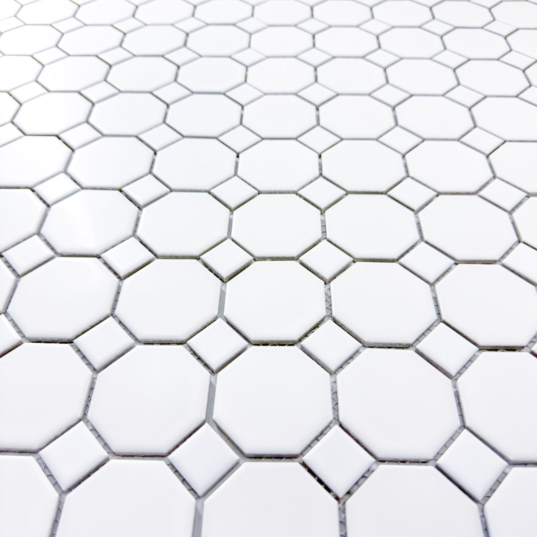 Upward angled view of a single sheet of Octa-Dot White, a classic timeless geometric pattern white octagon and dot penny mosaic tile with a mesh backing. 