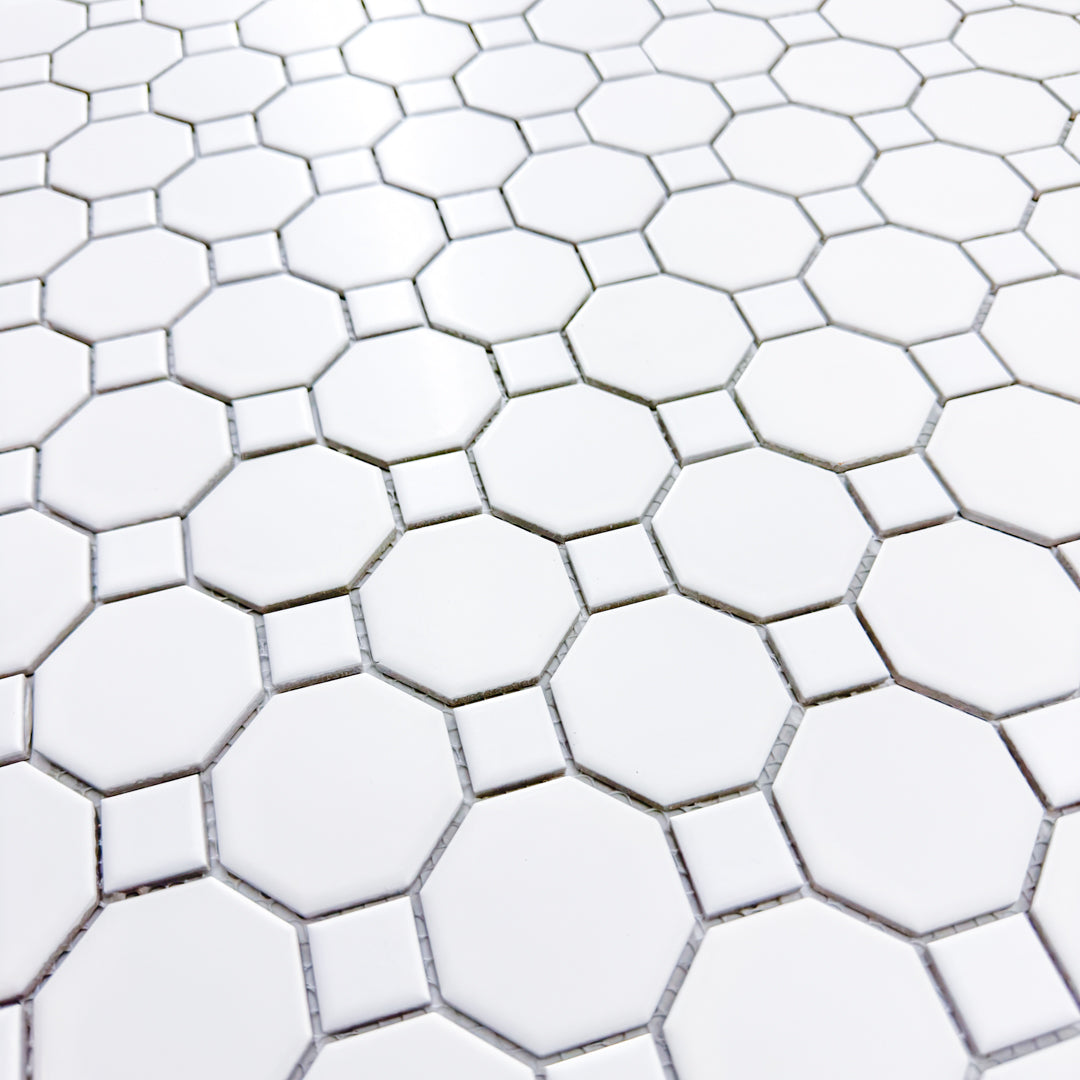 Zoomed in angled view of a single sheet of Octa-Dot White, a classic timeless geometric pattern white octagon and dot penny mesh backing mosaic tile. 