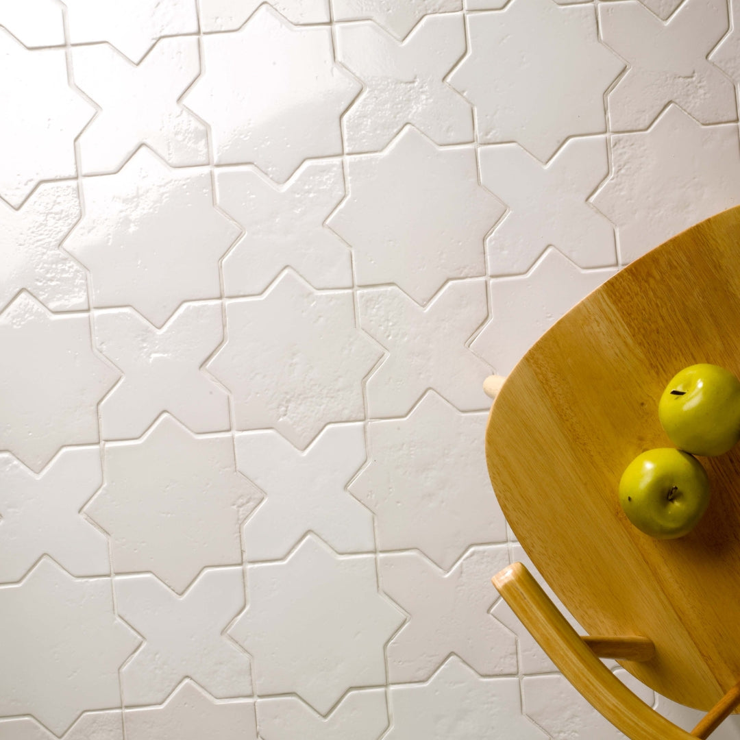 An installation showing white glossy star and cross tiles with subtle texture. 