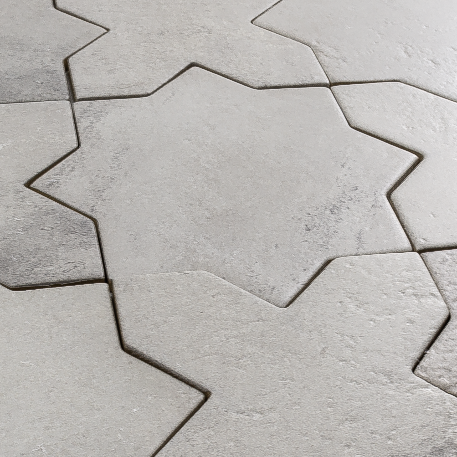Angled close up of a group of star and cross shaped tiles interlocking together in a matte grey stone look finish