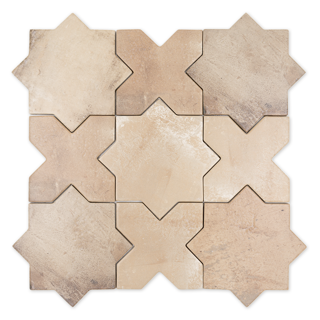 A group of star and cross shaped tiles interlocking together in a matte terracotta finish