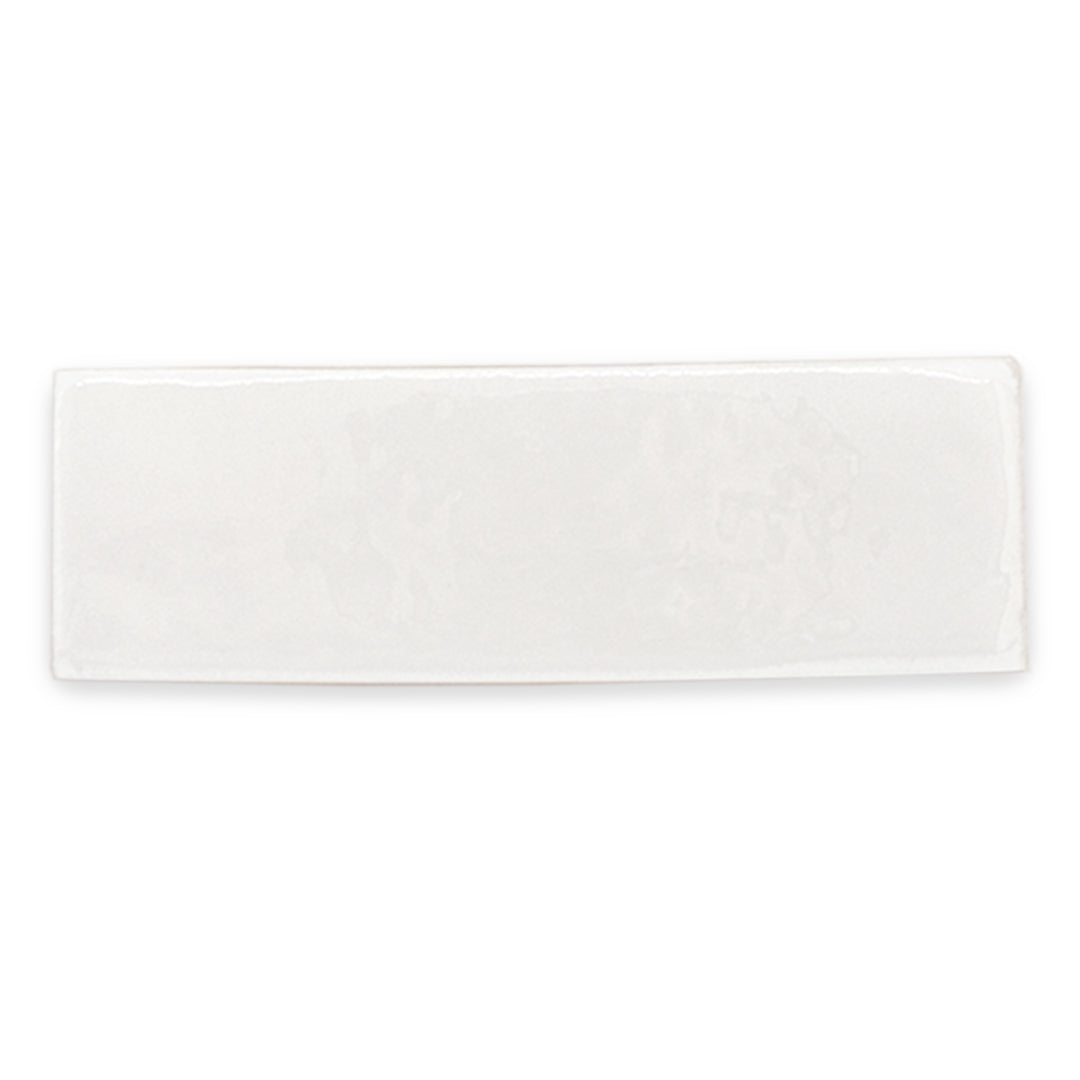 a single glossy 2x6 white tile with uneven edges for texture