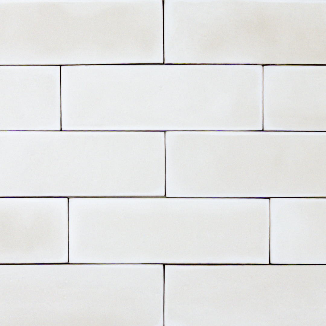 group of popcorn cloud white 2x6 matte subway tiles with a soft texture and uneven edges in a brick layout. 