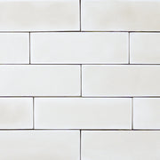 group of popcorn cloud white 2x6 matte subway tiles with a soft texture and uneven edges in a brick layout. 