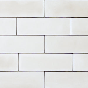 group of popcorn cloud white 2x6 matte subway tiles with a soft texture and uneven edges in a brick layout. 