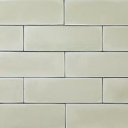 a group of light green sage2x6 matte subway tiles with a soft texture and variance in a brick layout. 