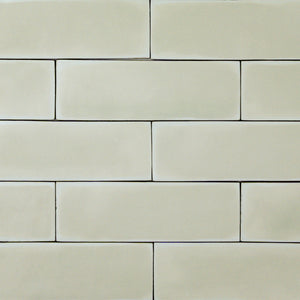 a group of light green sage2x6 matte subway tiles with a soft texture and variance in a brick layout. 