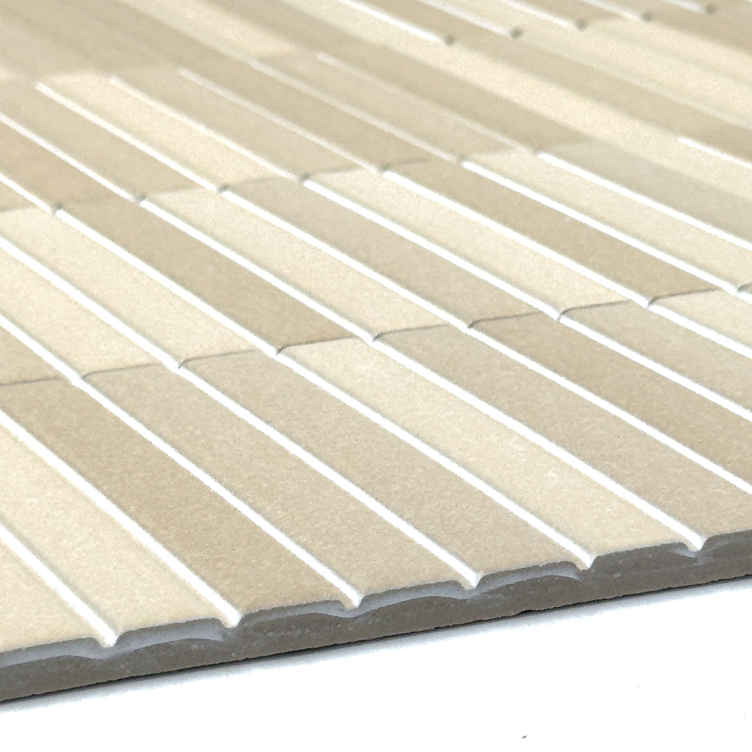 close up of the surface of a kitkat style panel in matte beige with colour variaiton to show the texture. 