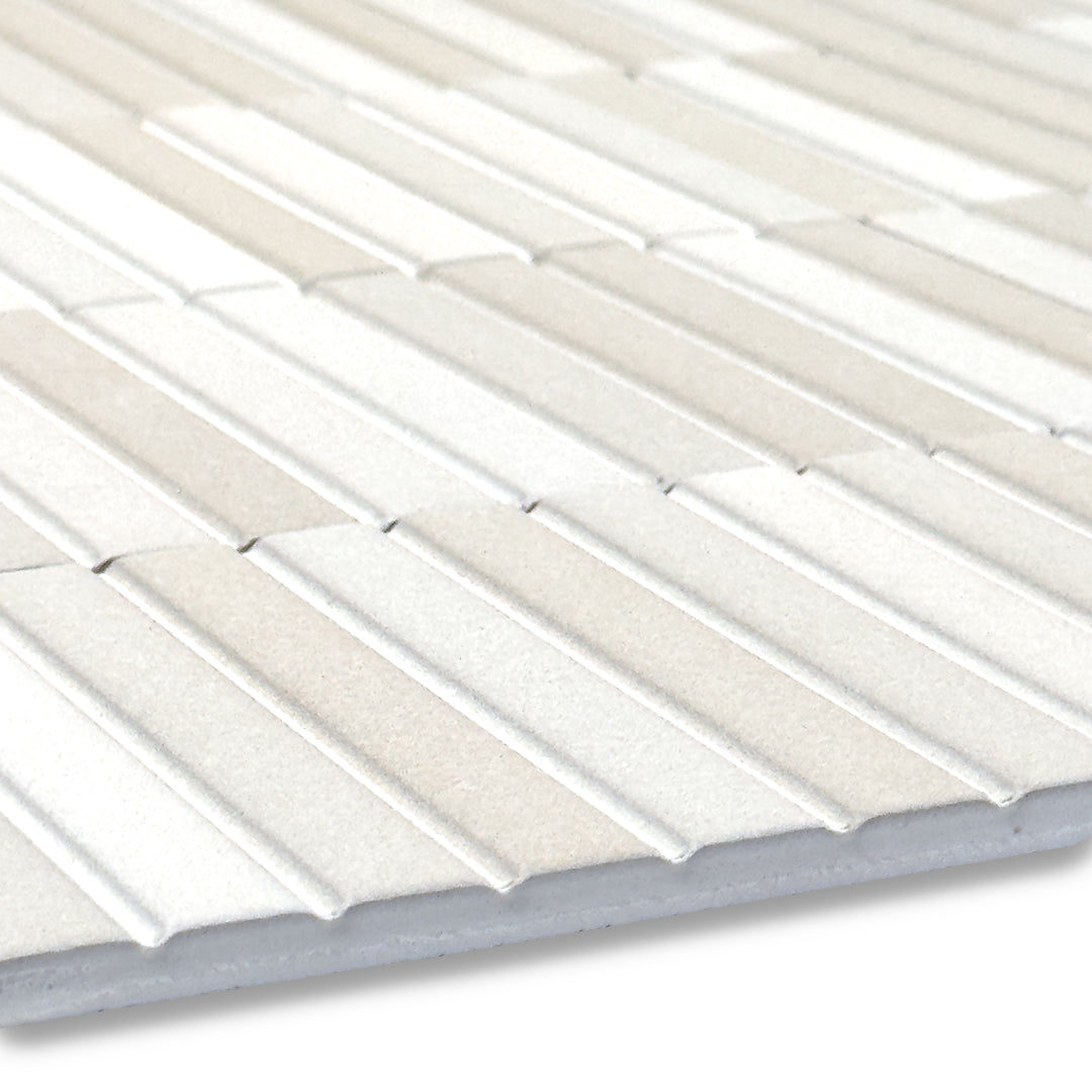 angled close up of the surface of a group of fluted kitkat style panel in matte creamy sand with colour variation