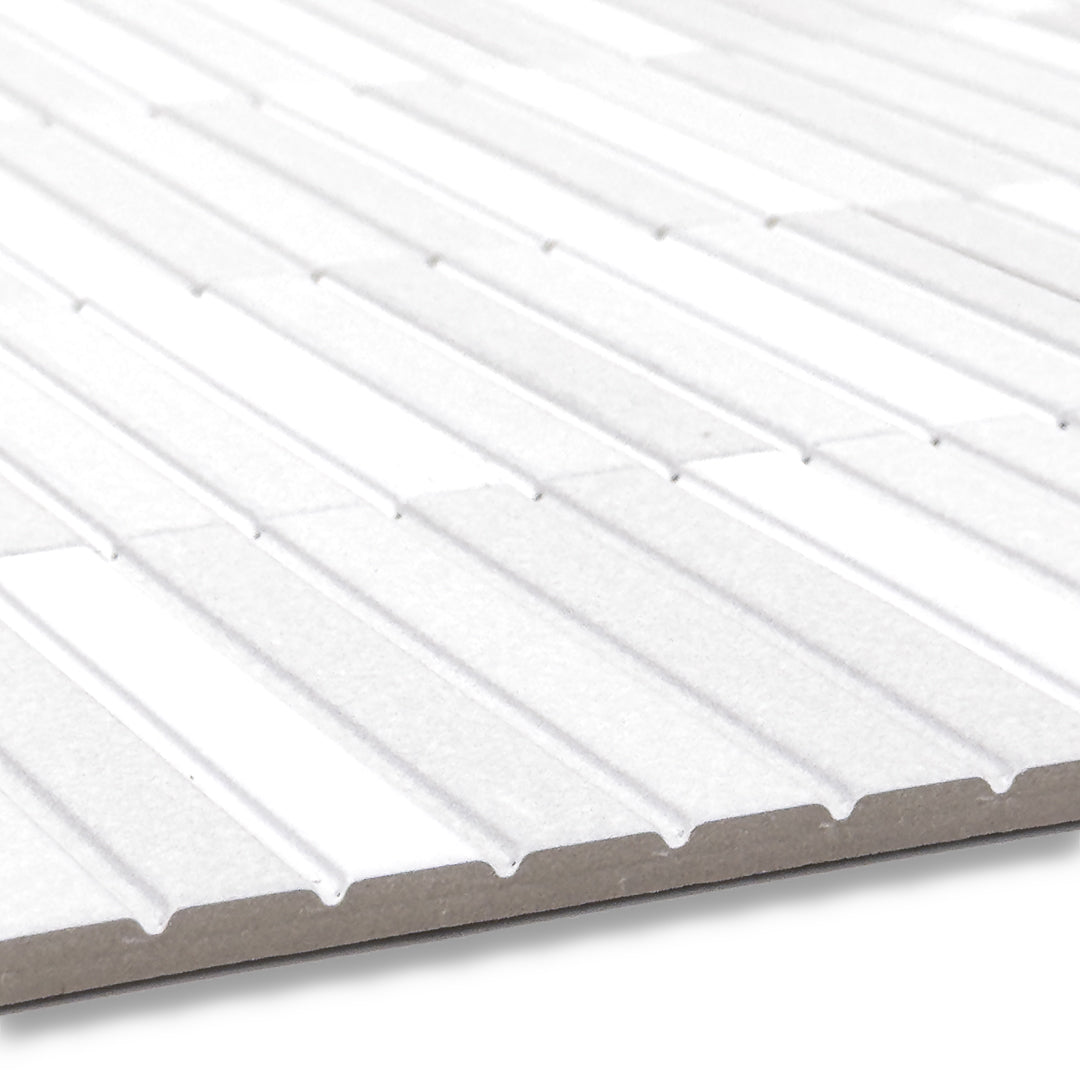 angled close up of show the surface and depth of a group of fluted kitkat style panel in matte white with a soft colour variation