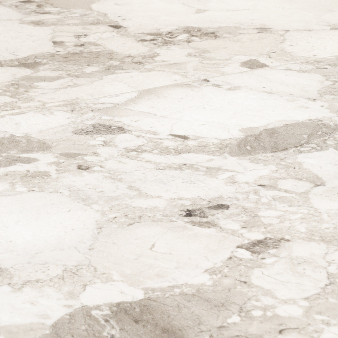 Angled close up view of two rectangular offwhite Rainstone powder terrazzo look tiles. 