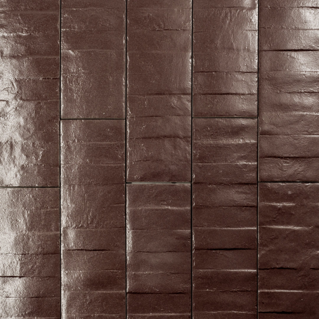 Ariel view of 3x12 textured burgundy wine tiles in a brick layout. 