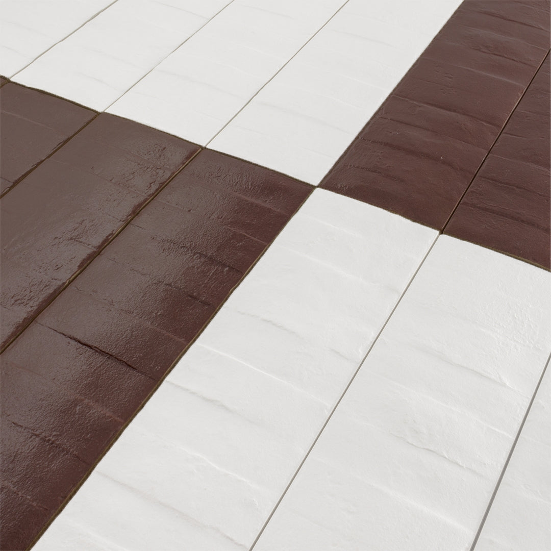 A close up of a checkerboard pattern layout of 3x12 white and burgundy textured tiles. 
