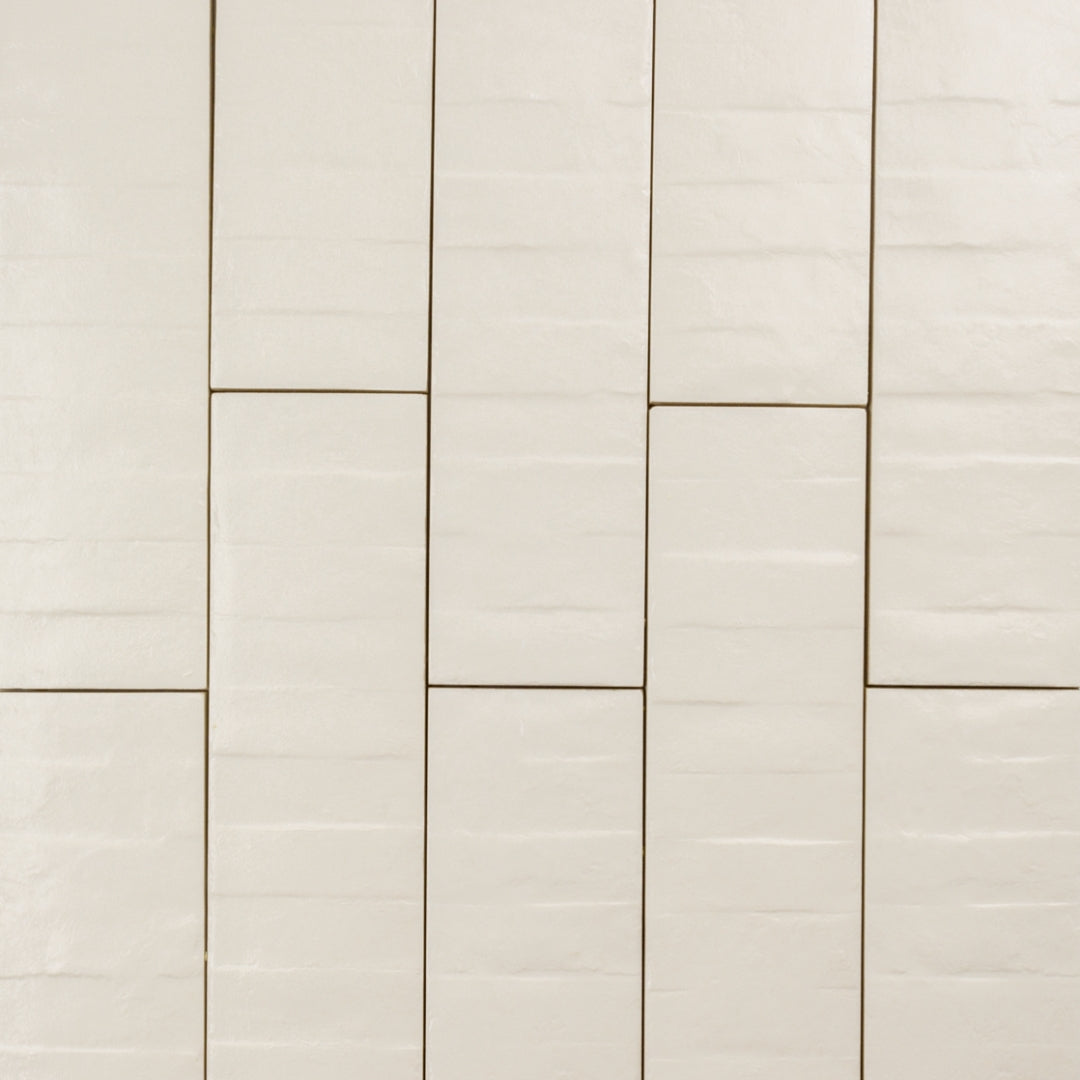 Ariel view of 3x12 band textured off white beige tiles in a brick layout. 