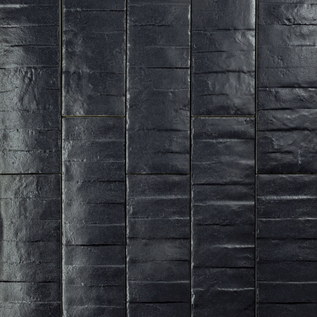 Ariel view of 3x12 band textured navy blue tiles in a brick layout. 