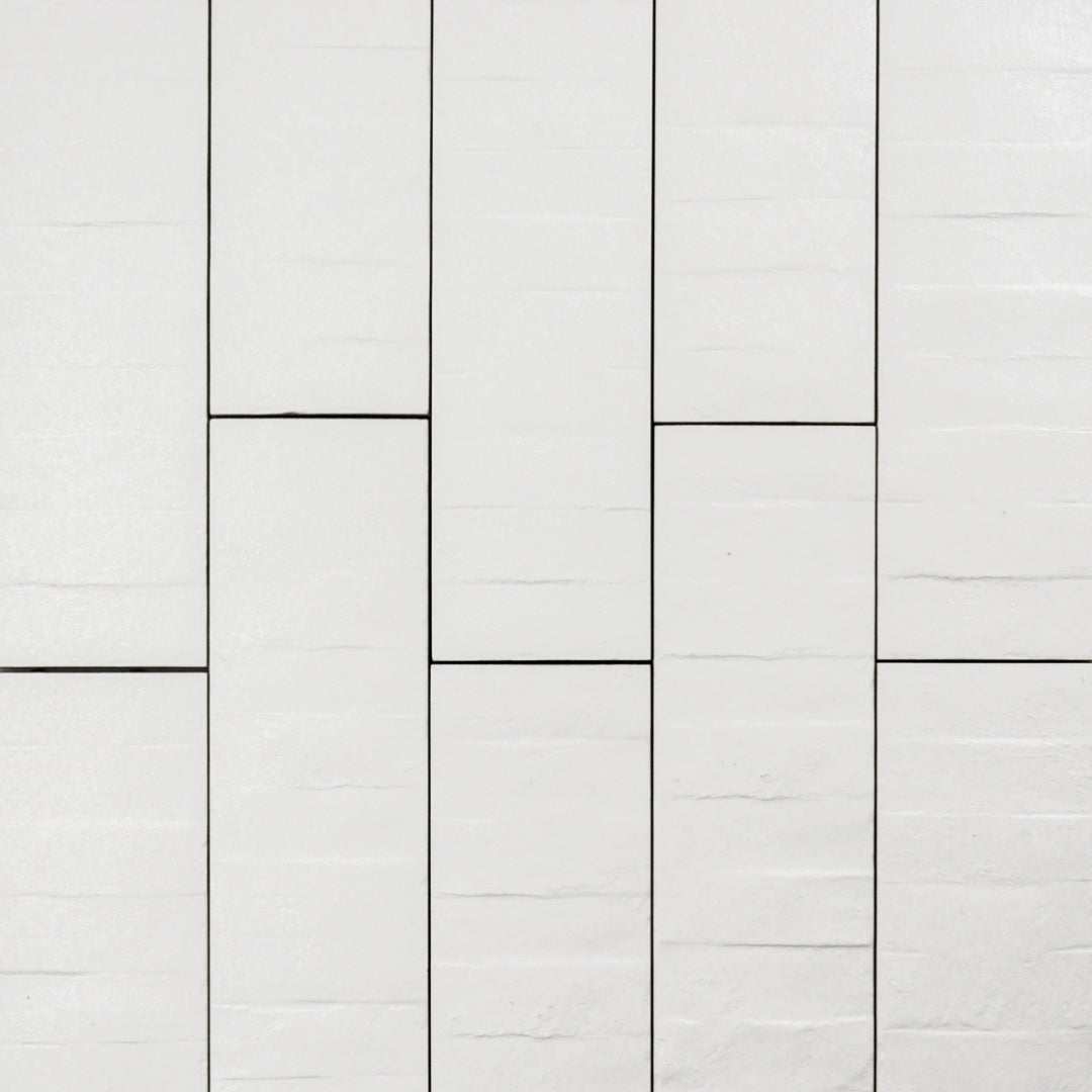 Ariel view of 3x12 textured white tiles in a brick layout. 