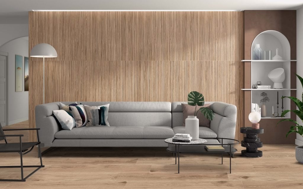 Modern natural living room with a reeded textured faux wood porcelain tile accent wall in light birch blonde. 