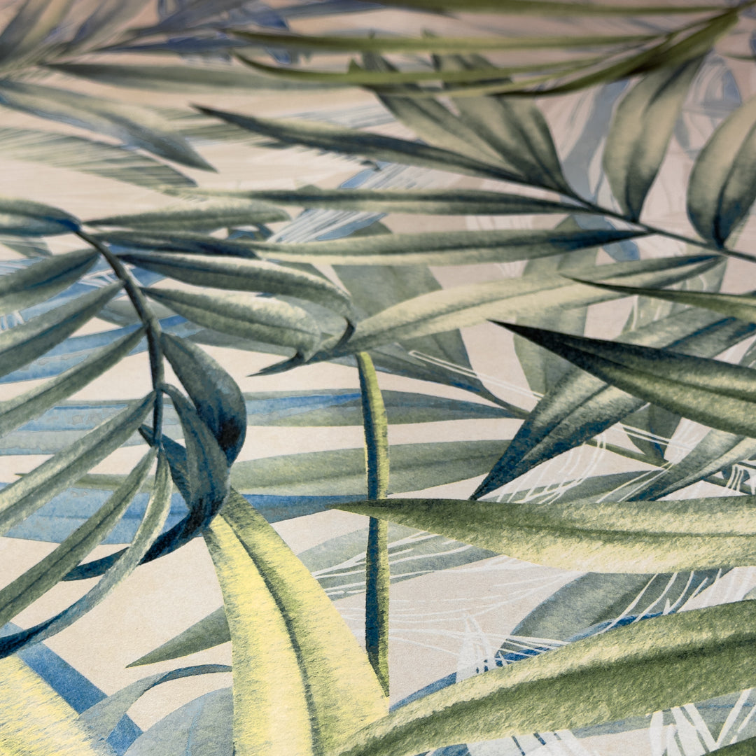 a close up of our jardin tiles that have a tropical pattern green leaves layered over a white background. 
