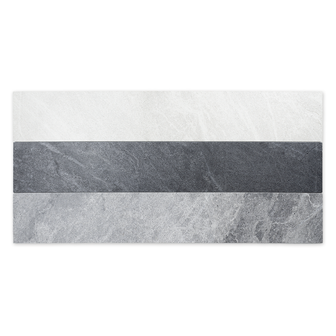 Ariel view of a group of three 4x24 stone look tiles in a stacked layout to show each available colour. There is white, dark grey and light grey. 
