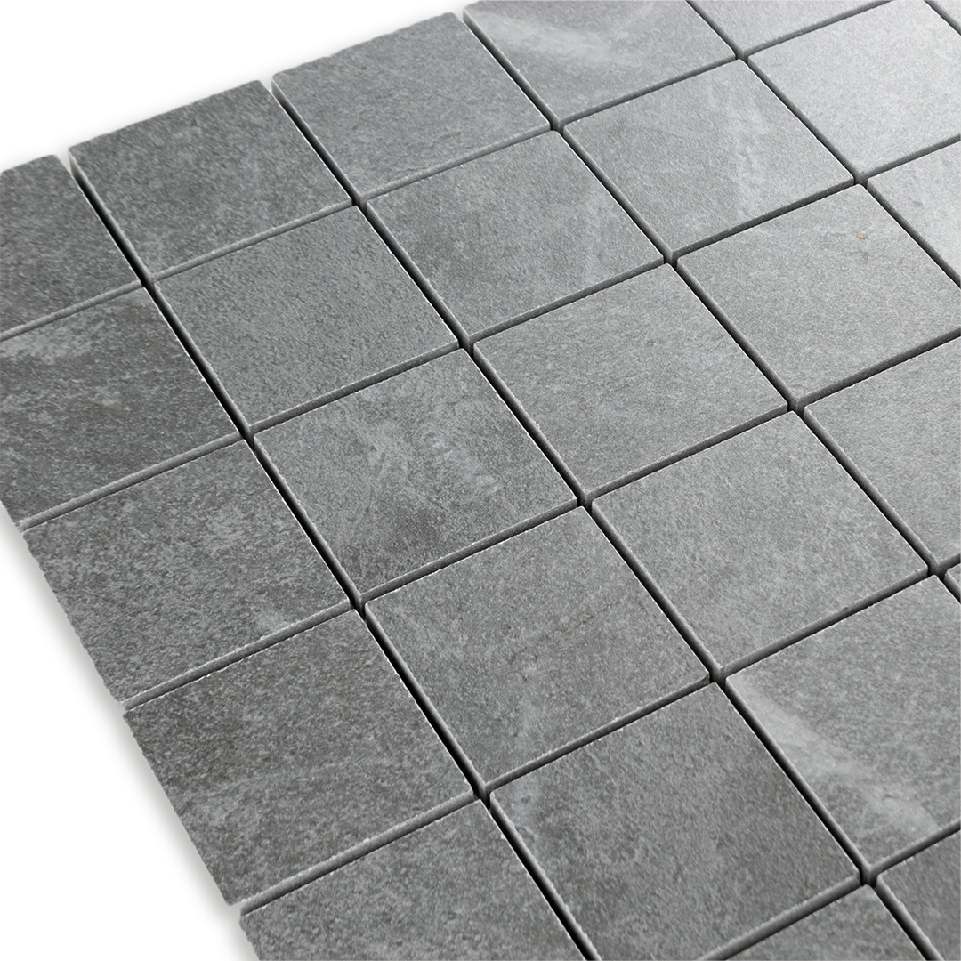 Angled close up of a grey 2x2 stone look mosaic tile sheet