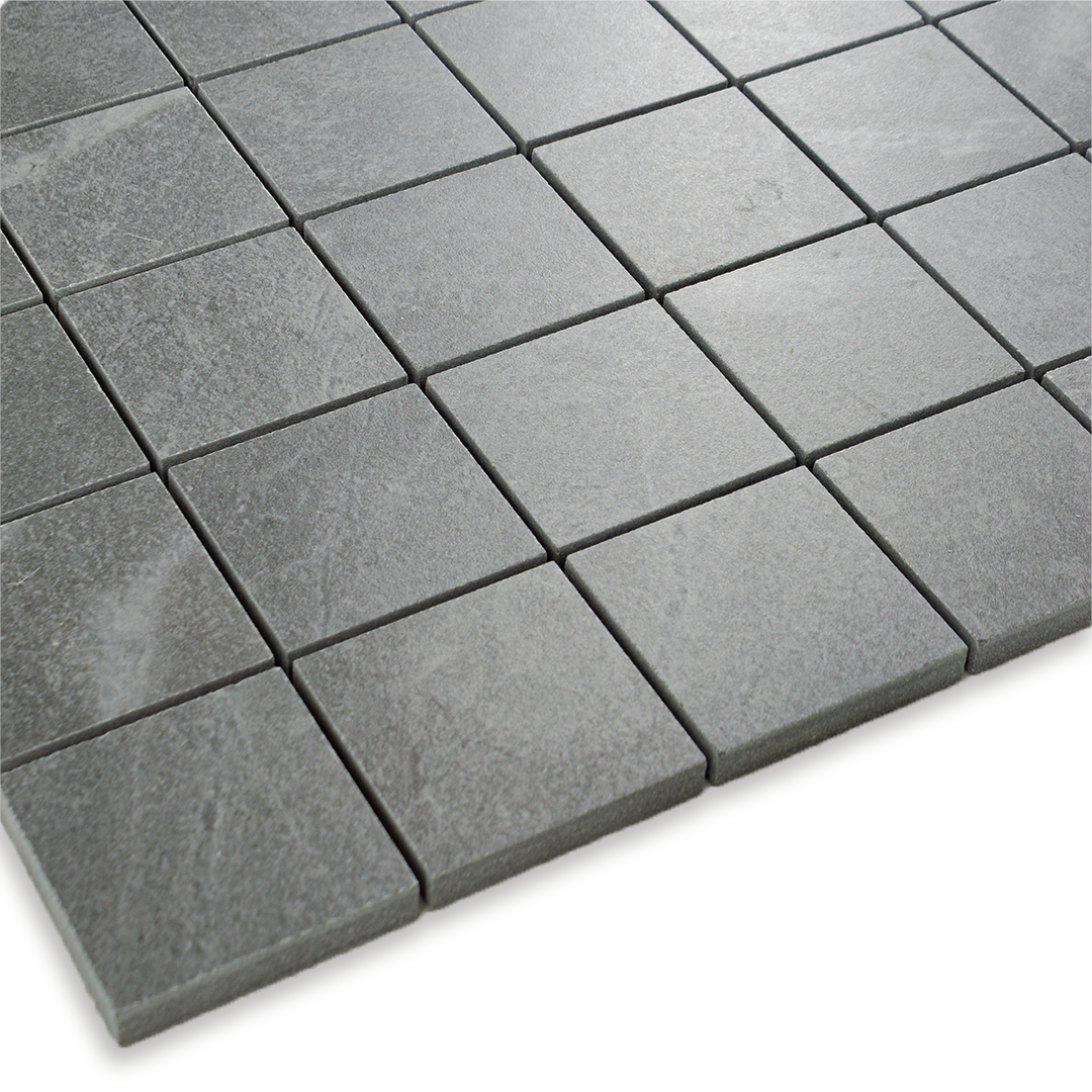 Angled close up of a grey 2x2 stone look mosaic tile sheet
