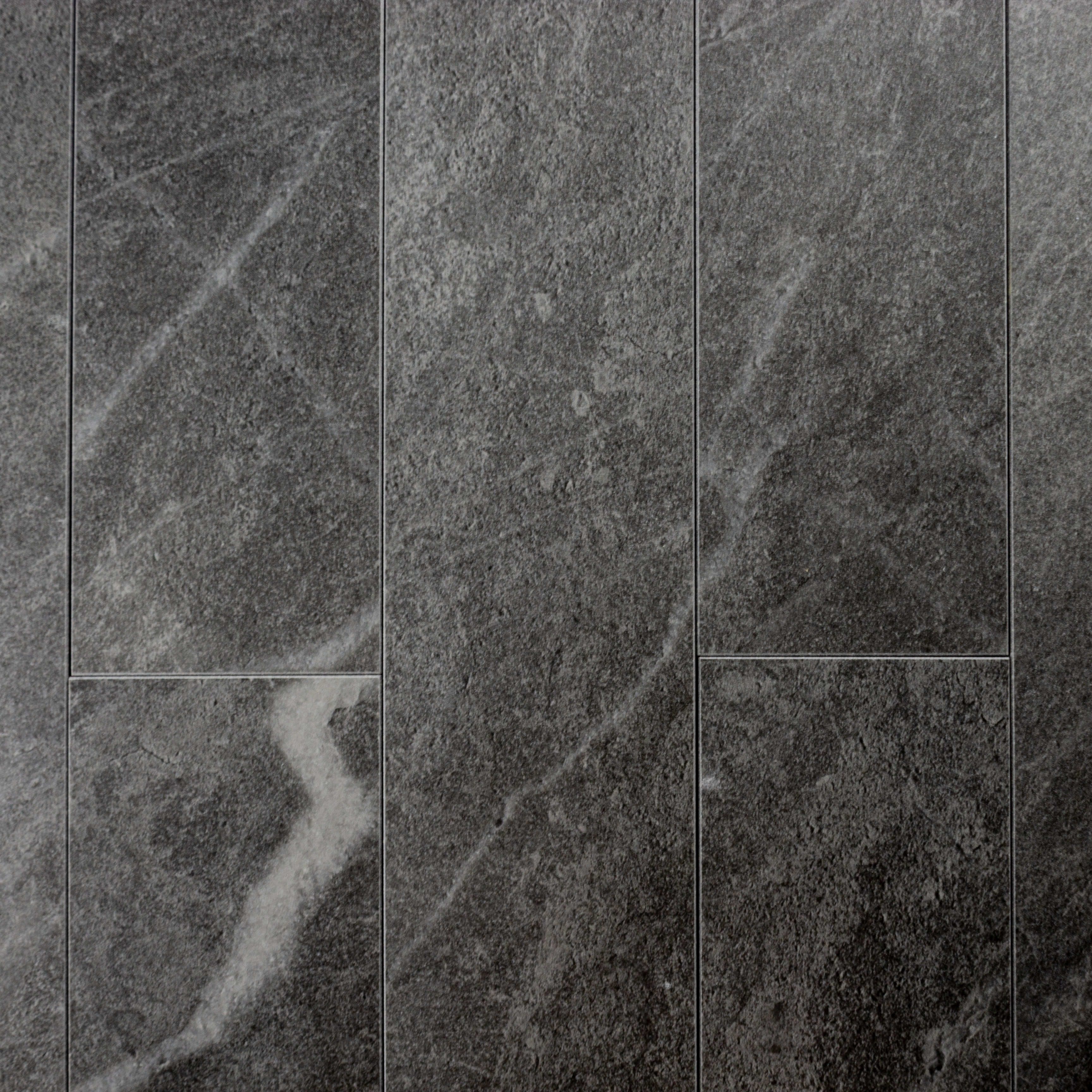 Ariel view of a group of 4x24 dark grey stone look tiles in a brick layout. 