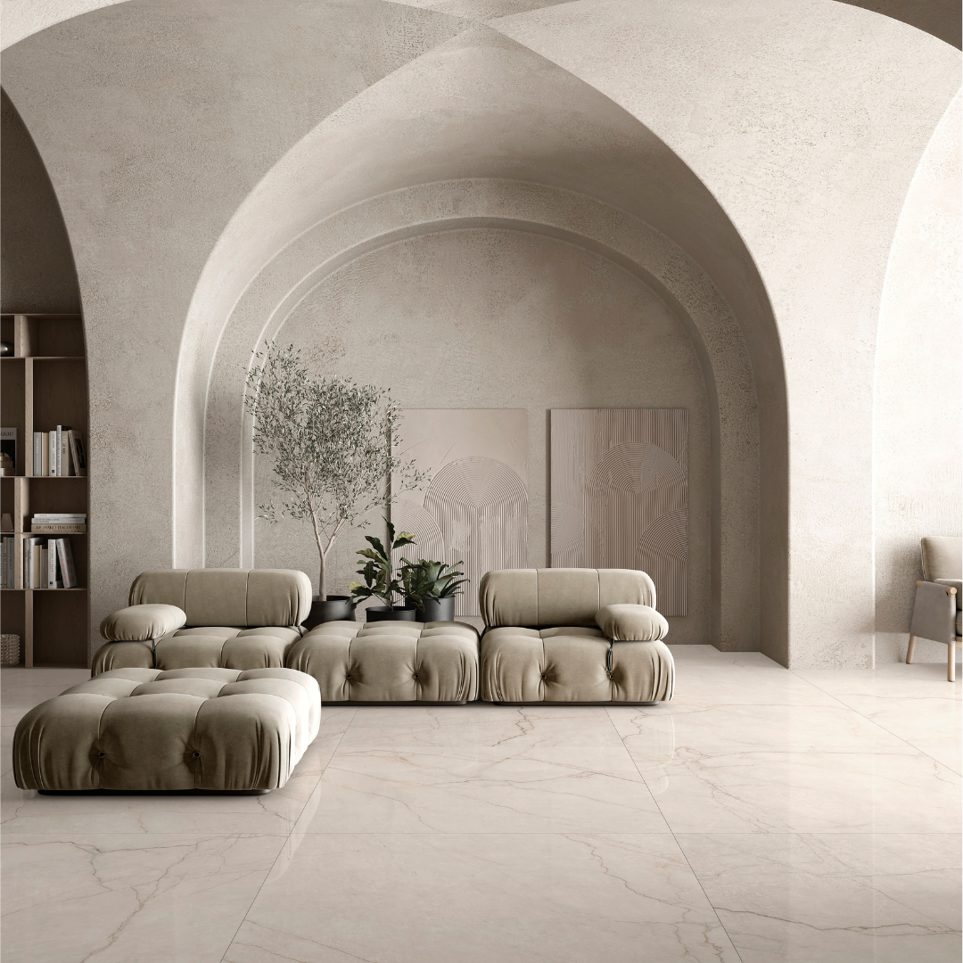 A neutral modern living space with limewash walls, arches and monochromatic look and warm white cream marble look tile flooring with fine delicate gold beige veining known as sanctuary avorio