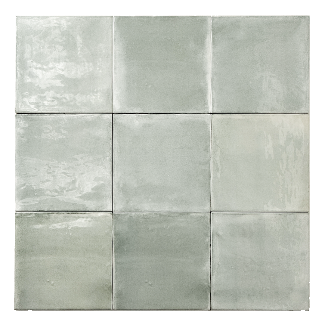 Ariel view of a group of glossy 5x5 textured light green blue earthy zellige tiles showing the textured edges and colour variation. 