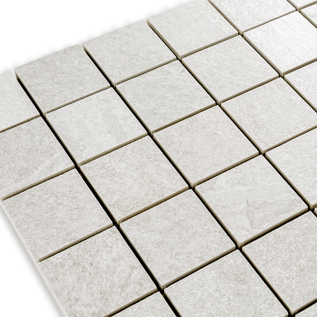 Angled close up view of a 2 inch square 12x12 sheet mosaic in a slate look white frost stone. 