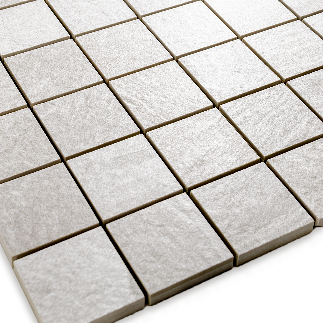 Angled close up view of a 2 inch square 12x12 sheet mosaic in a slate look white frost stone. 