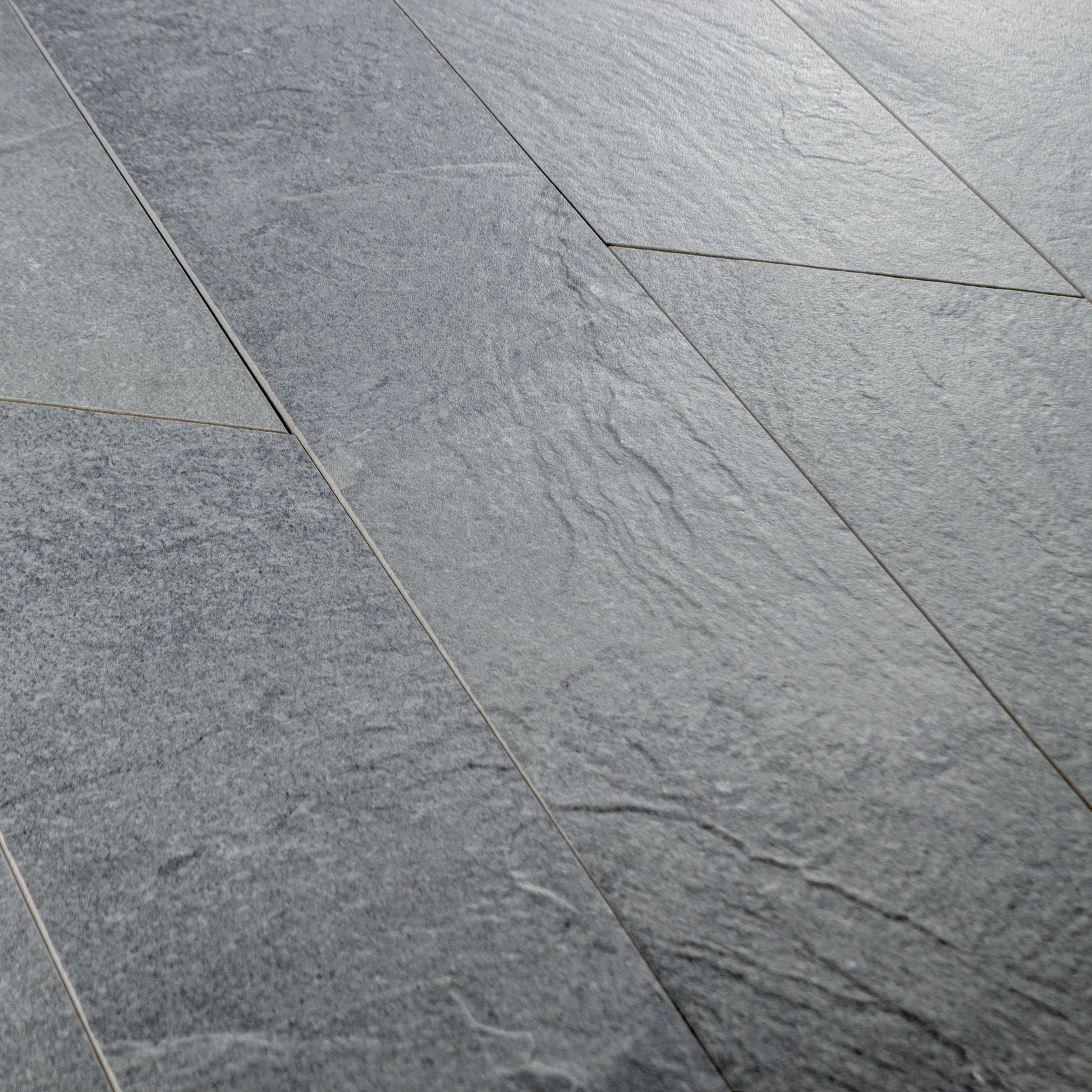 A group of 4x20 grey chevron stone look tiles to highlight the shape, and texture. 