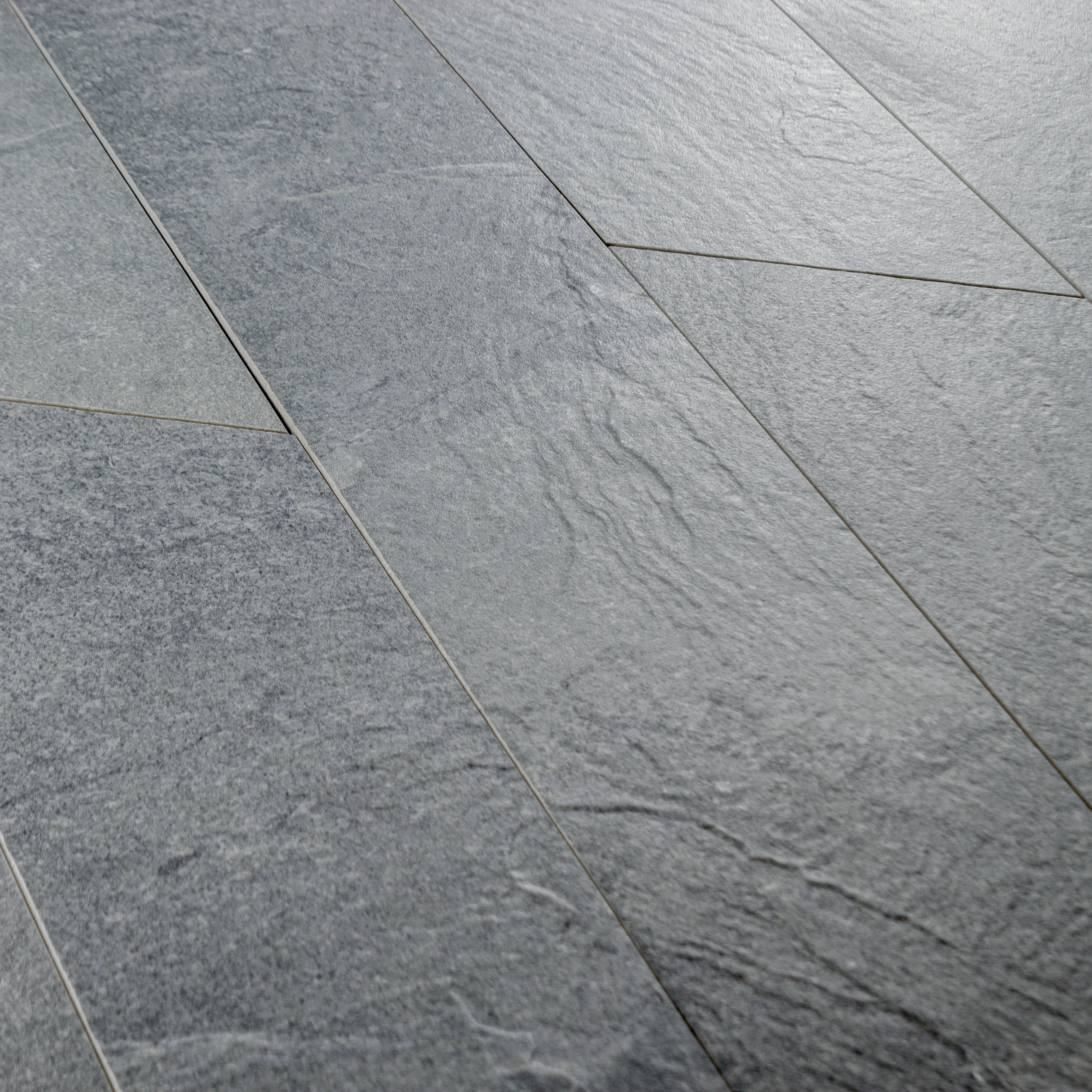 A group of 4x20 grey chevron stone look tiles to highlight the shape, and texture. 