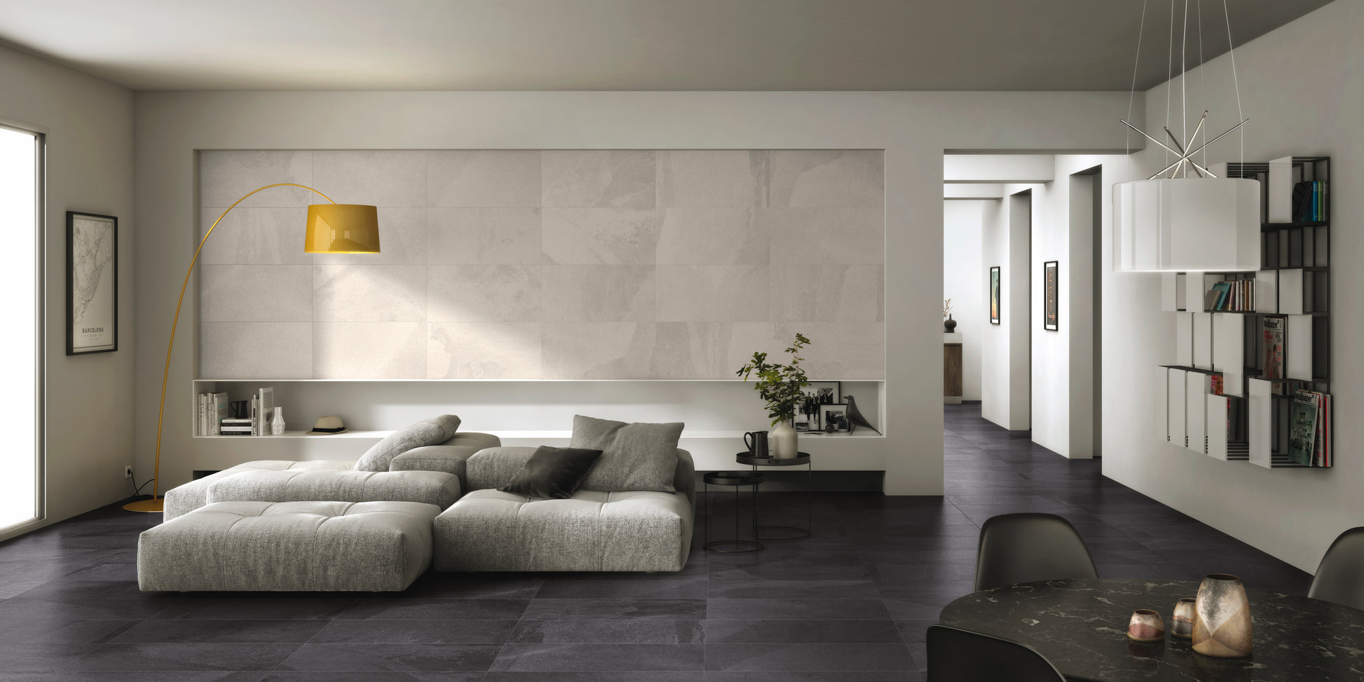 A modern family room with black slate look tiles on the floor and hallway. The painted walls, and accents are white to give a high contrast monochromatic look. 