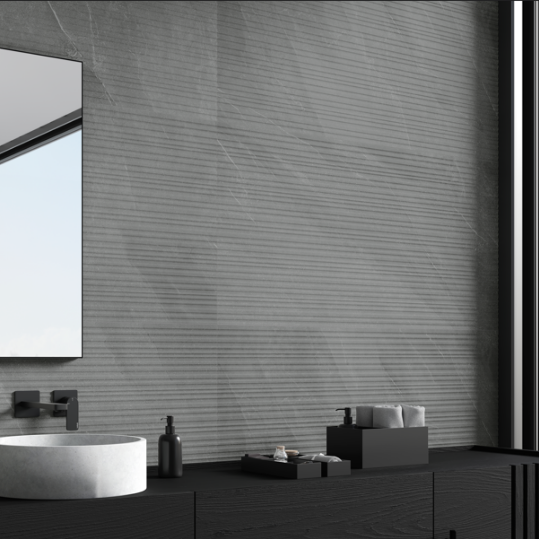 A dark grey limestone look tile with structured lines across the 24x48 running horizontally. The tiles are installed as a bathroom vanity backsplash with black vanity and accents. 