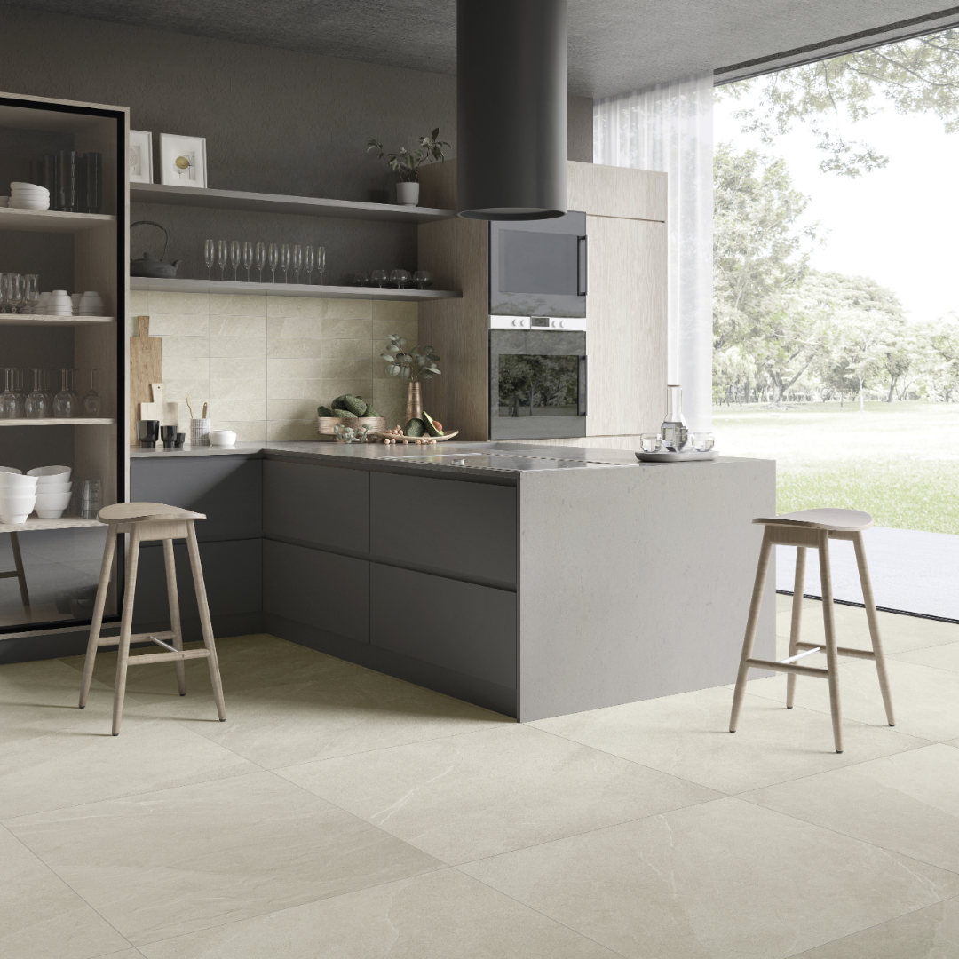 A modern charcoal cabinet kitchen with light wood accents. the stonehaven light stone look tile with very fine pattern and colour variance is in 4x12 on the backsplash and 24x24 on the floor for a minimalist cohesive natural look with minimal grout lines. 