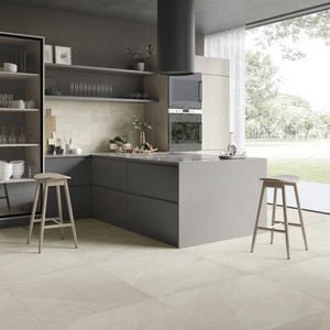 A modern charcoal cabinet kitchen with light wood accents. the stonehaven light stone look tile with very fine pattern and colour variance is in 4x12 on the backsplash and 24x24 on the floor for a minimalist cohesive natural look with minimal grout lines. 