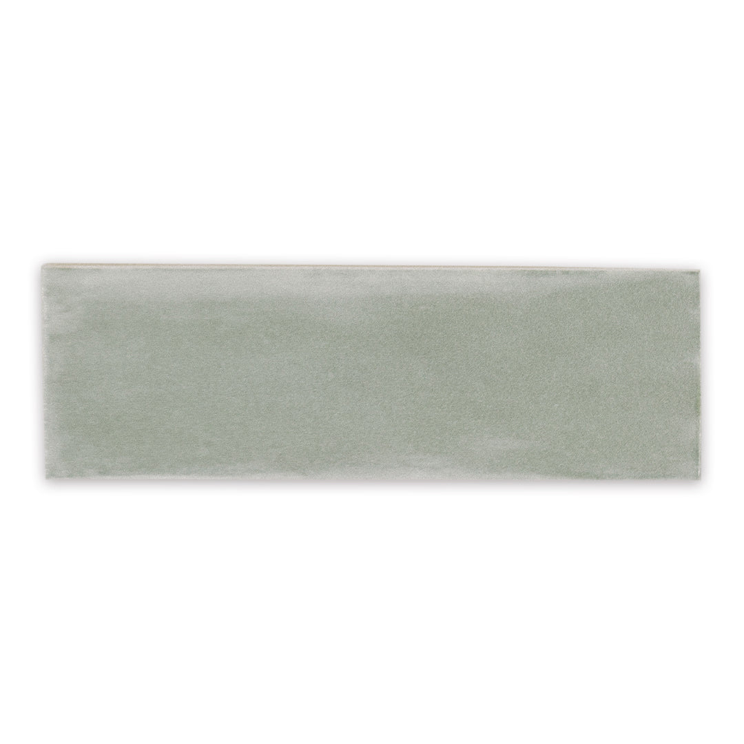 A single 2x6.5 glossy aquamarine blue green seaglow seaglass subway tile. 