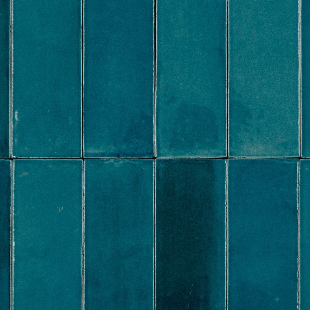 Ariel close up of 2x6.5 ocean bars in a stacked layout; a glossy cobolt sapphire blue tile with heavy colour variation. 