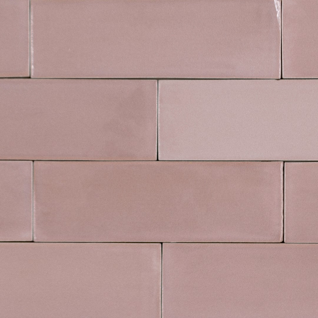 A brick layout tile flat lay featuring 2x6.5 whimsy pink bars; a glossy pink tile with heavy colour variation. 