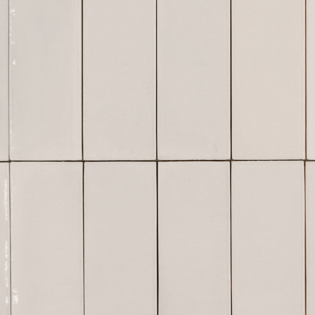 Ariel view of a stacked tile layout, the tiles are 2x6.5 glossy bars subway tiles in biscuit sepia beige cream taupe with heavy colour variation 