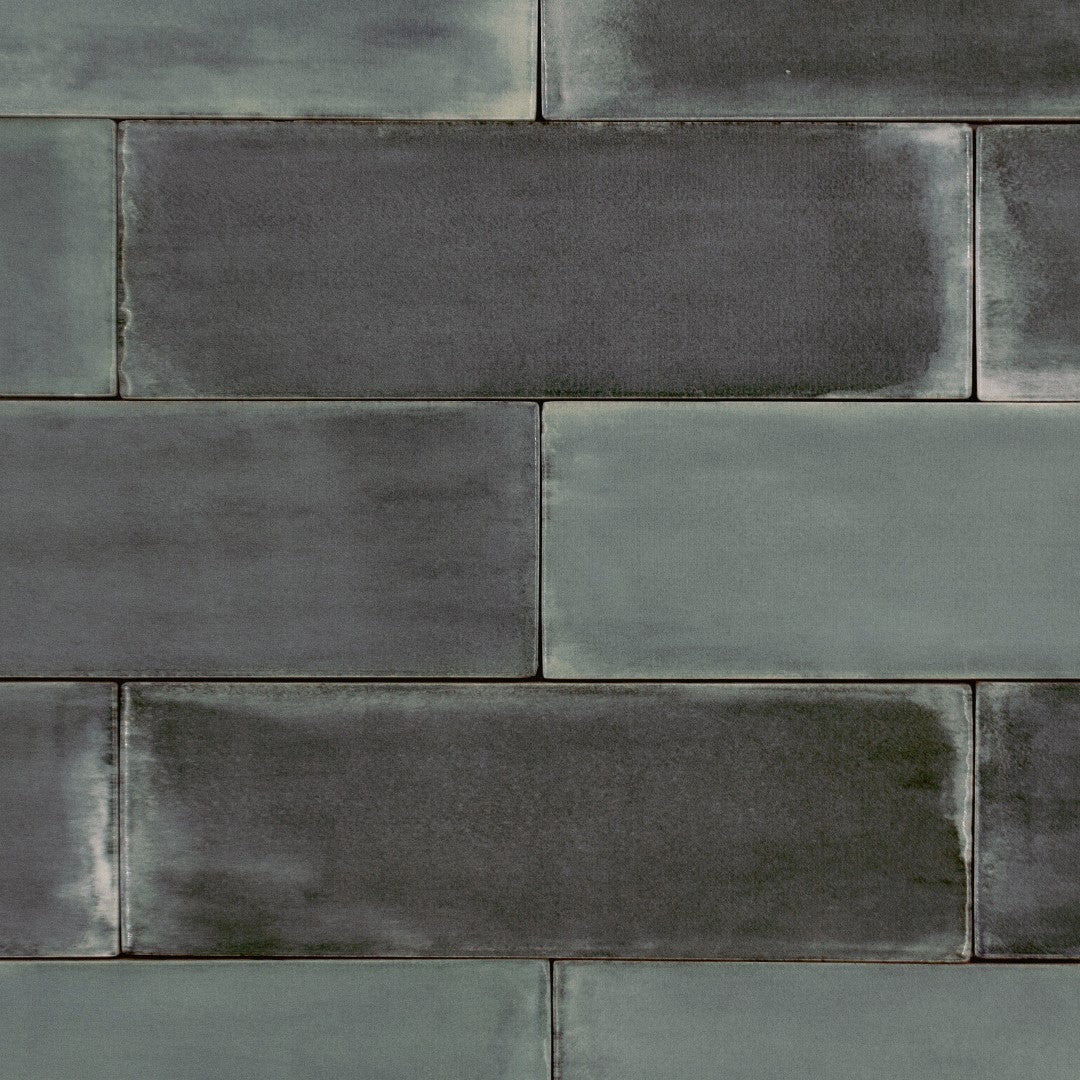 Ariel view of a brick layout tile flat lay where the tiles are 2x6.5 glossy flint bars dark grey subway tiles. 