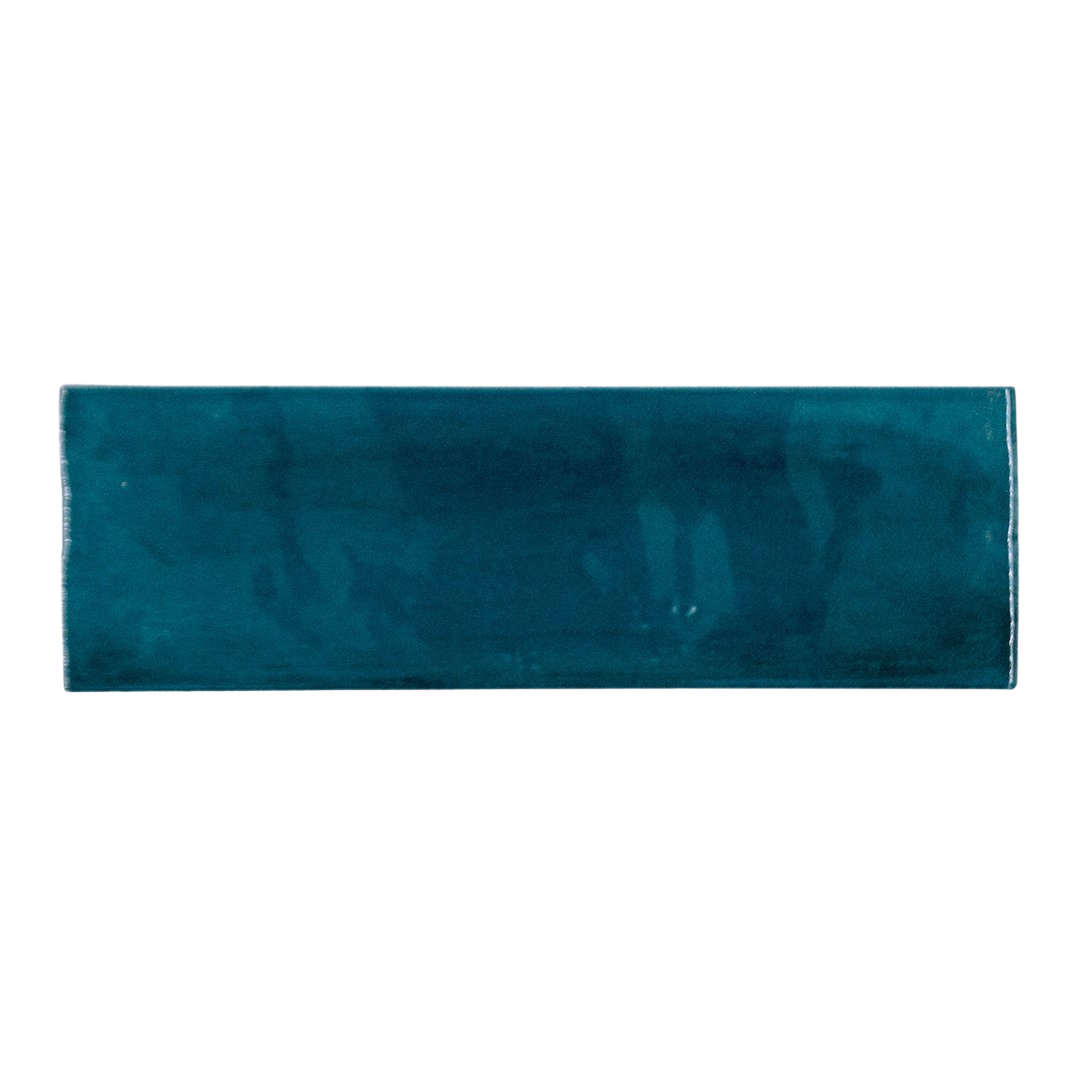 A single ocean blue 2x6.5 glossy bars subway tile. 