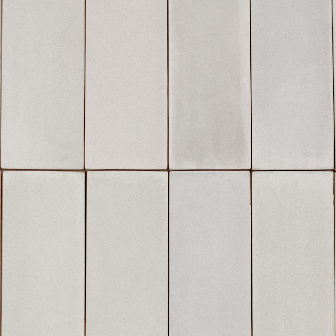 A stacked grouping of 2x6.5 sand bars tiles; a matte cream beige light warm taupe tile with heavy colour variation. 