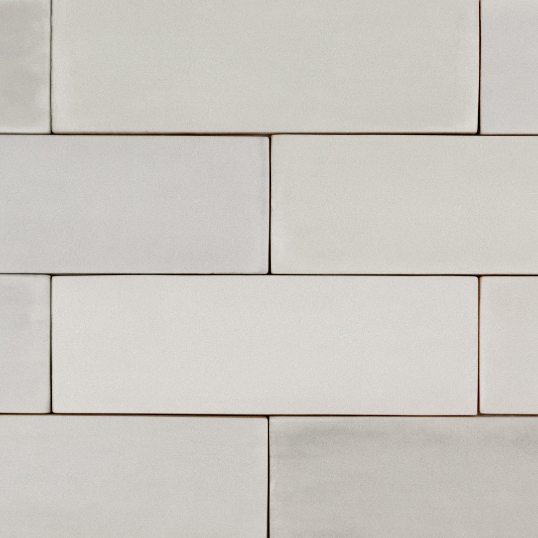 a brick tile layout close up of 2x6.5 sand bars; a matte cream beige light warm taupe tile with heavy colour variation. 