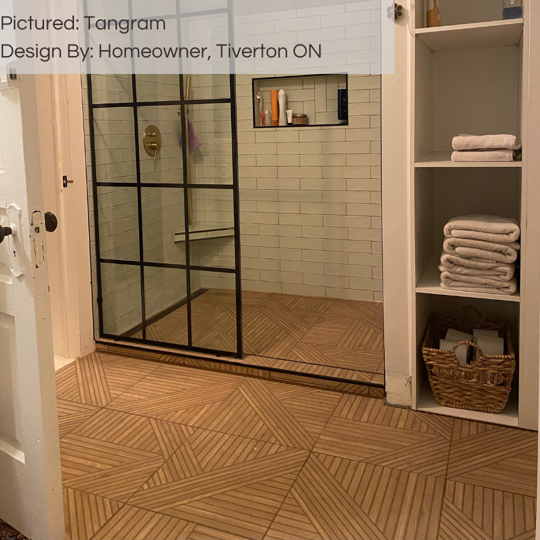 A stunning bathroom with tangram oak wood look geometric pattern tiles on the floor and extending into the modern  glass walk in shower. 