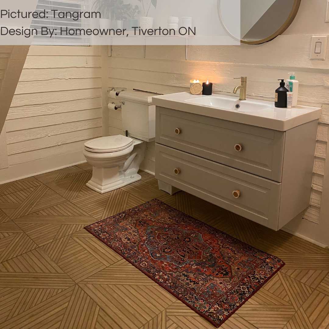A farmhouse style bathroom with shiplap and light coloured vanity. The floors are tangram oak wood look geometric pattern tiles. 