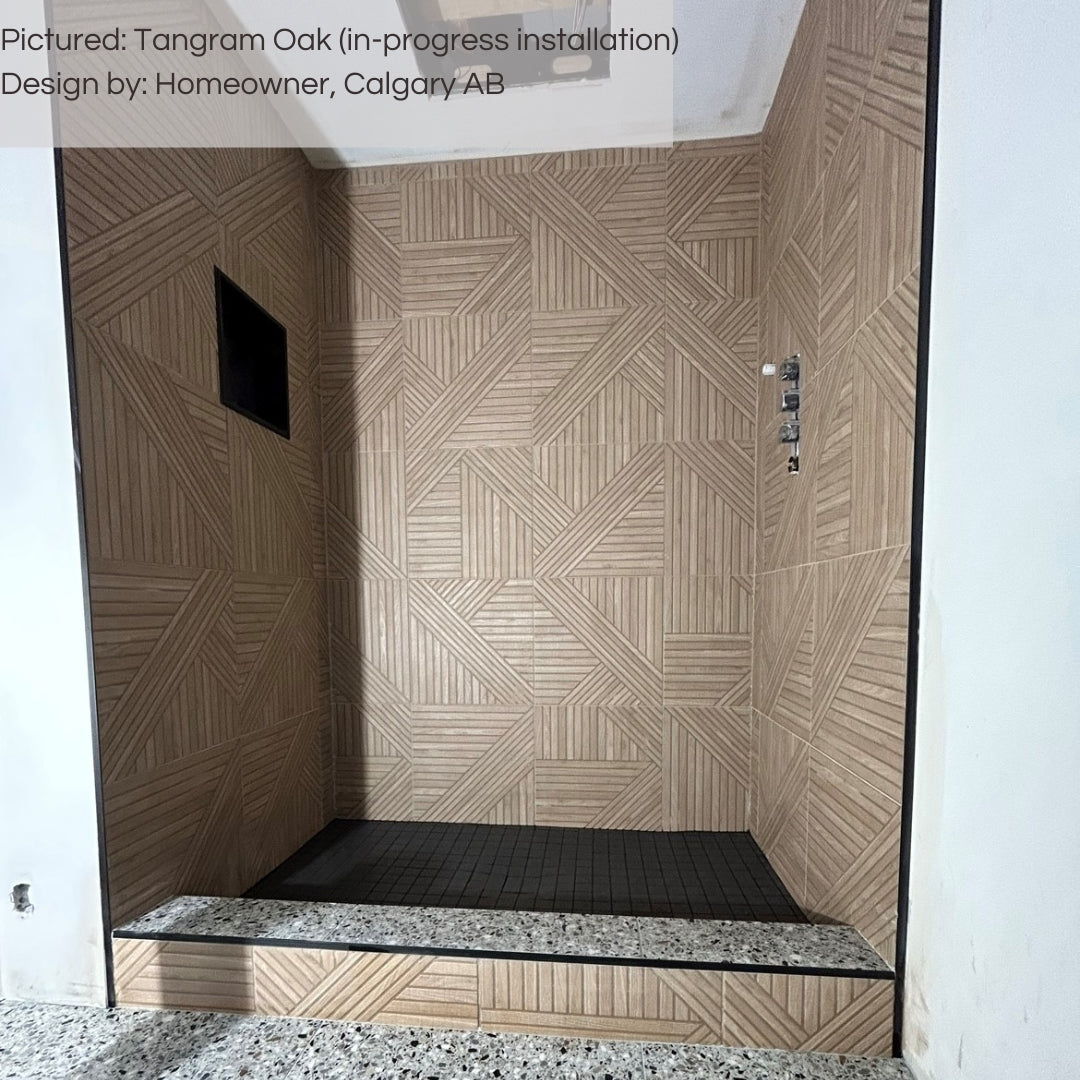A walk in shower with black floors and accents, and tangram oak wood look tiles on the walls. the wood grain is a neutral brown and the fluted pattern is geometric and adds texture. 