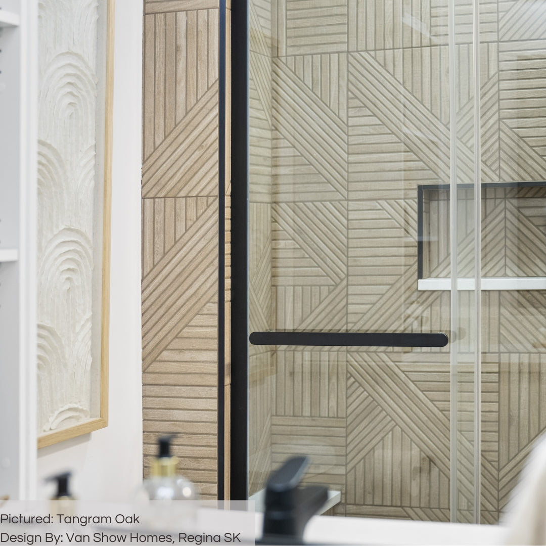 A clsoe up of a bathroom walk in shower wall with tangram oak geometric pattern 3d fluted tiles. 