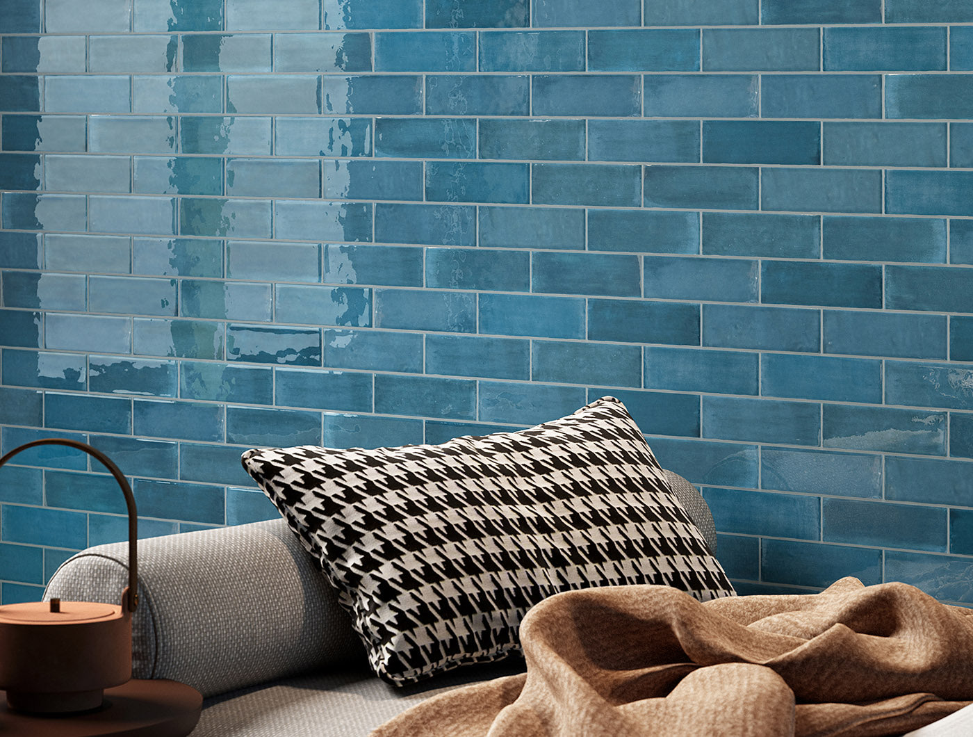 A tiled wall vignette featuring 2x6.5 ocean bars; a glossy cobalt sapphire blue tile with heavy colour variation. 